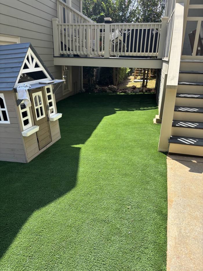 Turf install beside playhouse and deck