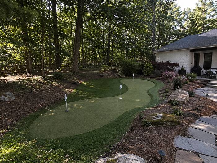 S-curve putting green beside brick home